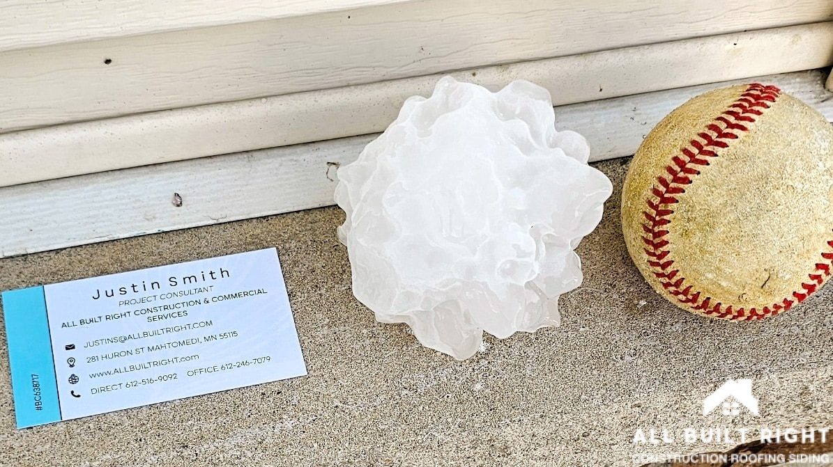 A baseball sized hail next to a baseball for scale in Monticello, MN